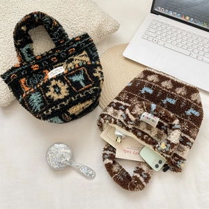 Close-up of plush jacquard tote bags with colorful geometric patterns and brand label