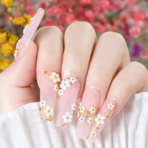 Elegant long coffin press-on nails in nude pink gradient with 3D white flowers and pearls