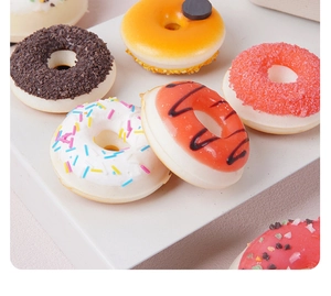 Assorted PU artificial donuts with colorful sprinkles and chocolate glaze on white stand
