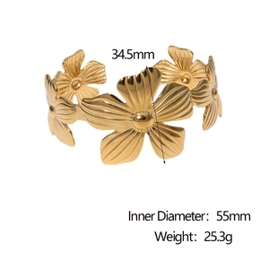 Detailed view of wide cuff bracelet featuring five golden metal flower motifs with dimensions