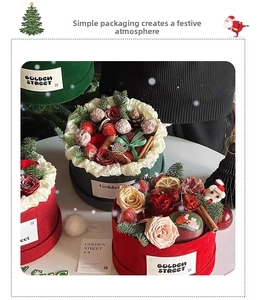 Top view of red and green velvet Christmas flower boxes with roses and festive ornaments