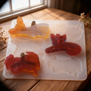 Moule en silicone pour barrettes animaux avec des pièces en résine pailletée sur bois