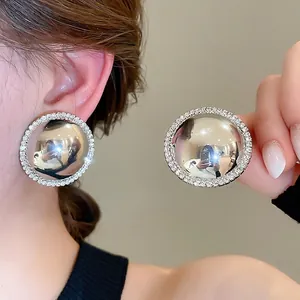 Chic silver round oversized stud earrings with a mirrored surface and crystal halo