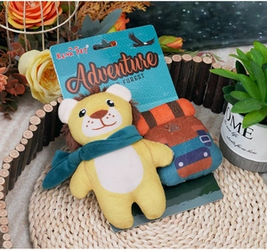 Detail of plush lion dog toy with green scarf and RENA PET brand packaging