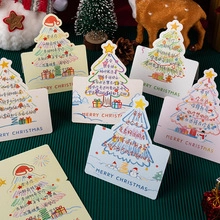 Close-up of 3D Christmas greeting cards with festive patterns on green background