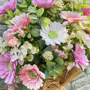 Pastel daisy and eucalyptus arrangement in a woven basket hanging decor for home