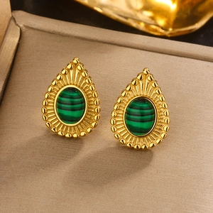Close-up of gold earrings with green malachite texture and beaded edge detail