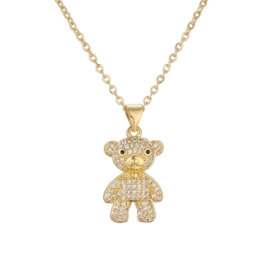 Detailed view of a gold-plated teddy bear pendant necklace with sparkling crystal inlay
