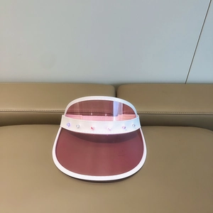 Detailed macro view of pink translucent PVC sun visor brim with decorative colorful beads