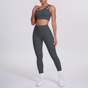 Detail of dark grey one-shoulder sports bra and high-waisted yoga leggings set