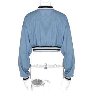 Rear view of cropped light blue denim jacket with black and white striped ribbed trim details