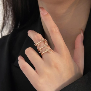 Detailed macro view of golden leaf wrap ring featuring intricate vine and vein textures