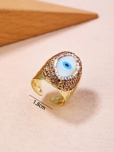 Detailed macro view of 14K gold-plated Evil Eye ring with sparkling rhinestones, size 1.8cm