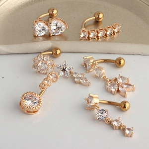Macro view of gold stainless steel belly rings with zircon stars, flowers and hearts