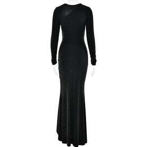 Detail view of the sleek fishtail hem and shimmering black fabric on the back of the gown