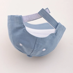 Detail view of the light blue toddler baseball cap with adjustable velcro strap and eyelets