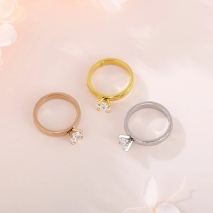 Three-color minimalist rings with claw-set zircon in gold, rose gold, and silver finishes