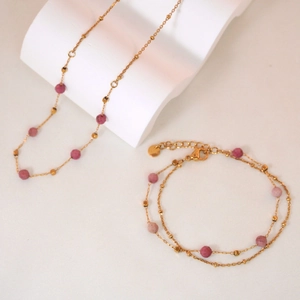 Luxurious gold stainless steel jewelry set with faceted pink stones and square beads