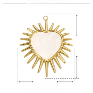 Detailed view of heart-shaped sunburst pendant made of gold stainless steel and shell