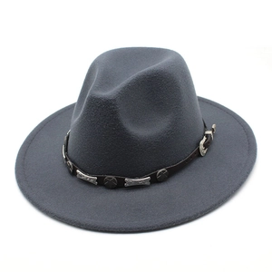 Detail of dark gray wool fedora with brown leather band and vintage metal studs