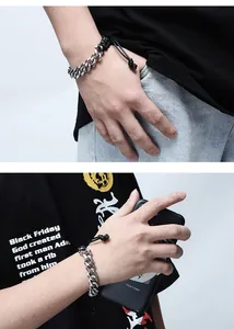 Detailed macro of a silver cuban chain bracelet with adjustable black braided rope cord