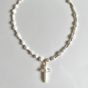 Vintage baroque pearl necklace featuring a shell cross pendant and golden accents