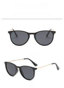 Front and 45-degree angle views of black oval sunglasses with gold metal temples