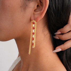 Luxurious 18k gold plated drop earrings with zircon tassels on a model's ear