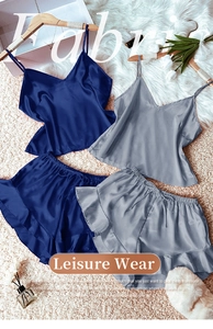 Detail of silk satin pajama set featuring V-neck camisole and ruffled drawstring shorts