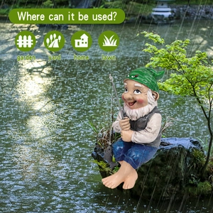 Resin fishing garden gnome ornament sitting on a rock near water for outdoor decor