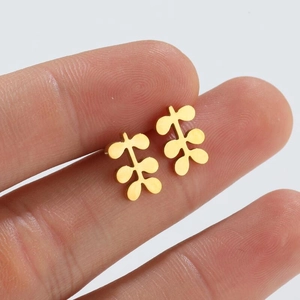 Gold leaf stud earrings featuring a minimalist three-pair leaf design on a white background