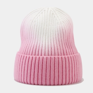 Detail shot of the pink and white ombre rib-knit winter beanie showing texture and gradient