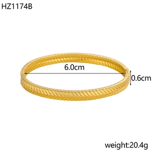 Detail view of 18K gold plated stainless steel bracelet with herringbone pattern engraving