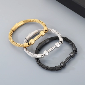Detailed view of stainless steel barbell bracelets in gold, silver, and black finishes