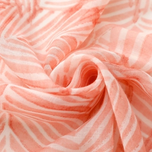 Close-up of lightweight pink and white striped fabric with soft breathable texture