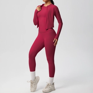 Detailed view of dark magenta three-piece yoga set showing seams and stretchy fabric texture