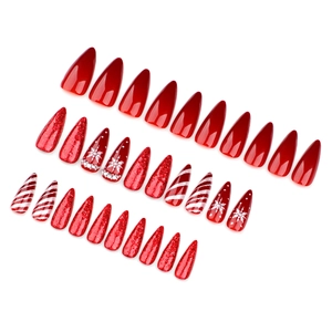 Unghie natalizie a pressione con strisce rosse, fiocchi bianchi e design a stiletto glitter