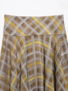 Close-up of a plaid midi skirt featuring an invisible side zipper and soft A-line cut