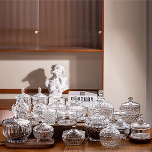 Elegant collection of clear glass storage jars with decorative lids in a stylish setting