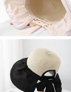 Detail of straw sun hat featuring a breathable hollow top and stylish decorative bow knot