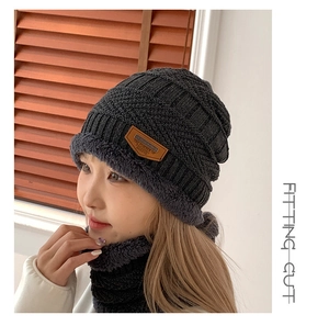 Detail view of the thick knit texture and warm fleece lining on dark grey winter hat set
