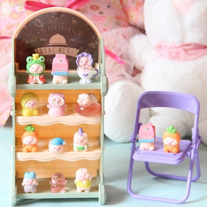 Miniature resin pig figurines in various costumes displayed on a tiered shelf