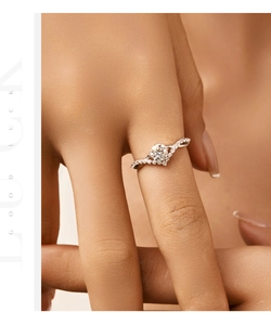 Close-up of elegant crown S925 silver ring with wavy band and moissanite stone