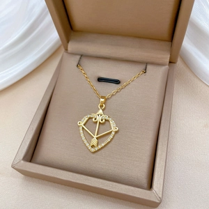 Luxurious gold cupid bow necklace with sparkling crystals displayed in a jewelry box
