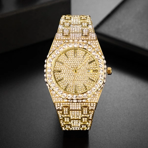 Macro detail of luxury gold quartz watch with full diamond inlay and octagonal bezel