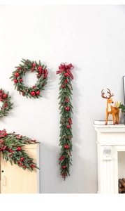 Close-up of frosted Christmas wreath detail with red berries and plaid bows