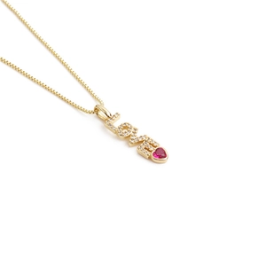 Minimalist gold LOVE necklace with red heart gemstone and sparkling crystal accents