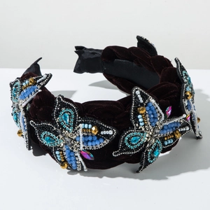 Detailed macro shot of vintage velvet headband with crystal butterfly beads and jewels