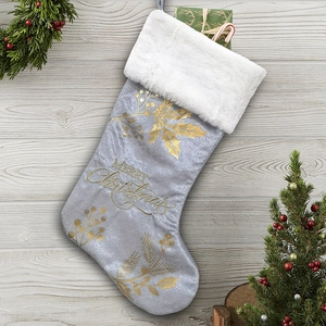 Detail of silver Christmas stocking with gold Merry Christmas print and white faux fur cuff