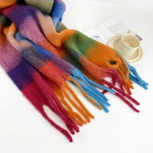 Macro detail of rainbow checkered mohair scarf featuring long tassels and soft knit texture